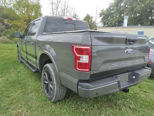 Completed grey Ford F-150 rear three-quarter after repair