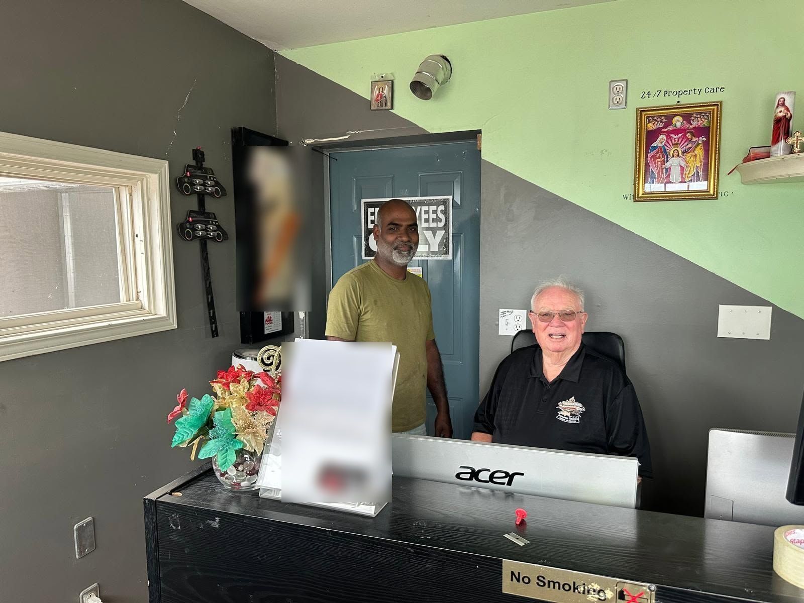 Two people at the reception counter inside Andrew Auto Collision Repair