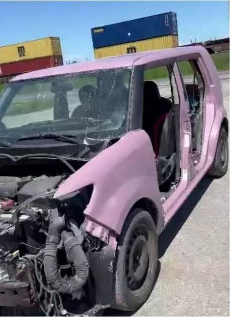 The Scion xB body shell coated in pink primer