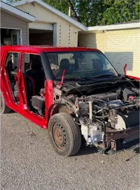 The Scion xB body shell stripped of panels in the yard